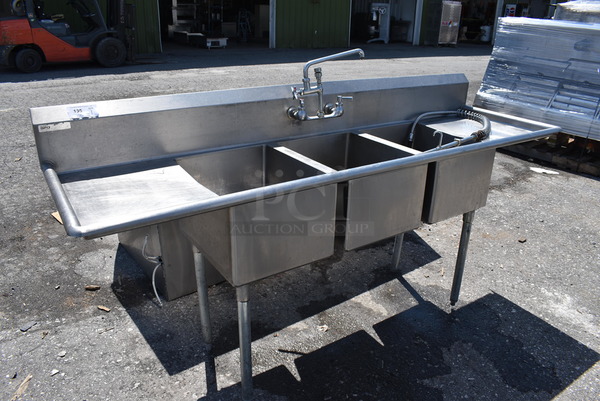 Stainless Steel Commercial 3 Bay Sink w/ Dual Drainboards, Faucet, Handles and Spray Nozzle Attachment. 88x27x44. Bays 16x20x12. Bays 17x23x2