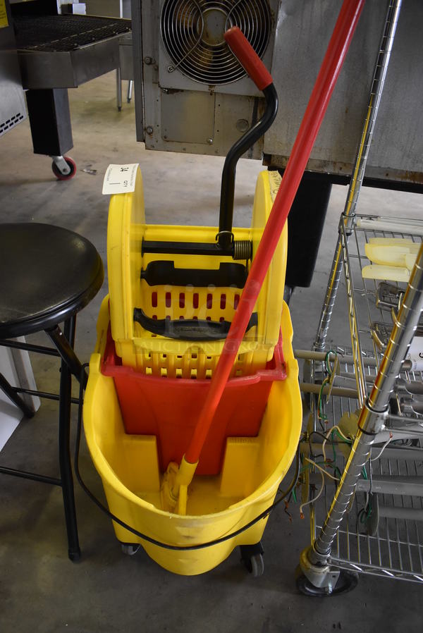 Yellow Poly Mop Bucket w/ Wringing Attachment and Mop Handle on Commercial Casters. 16x22x37