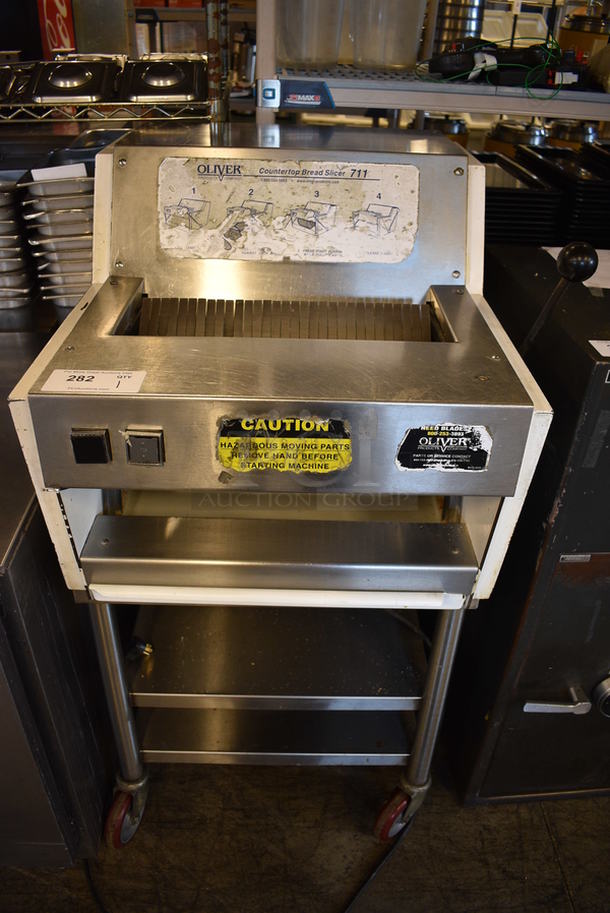 AWESOME! Oliver Model 711 Stainless Steel Commercial Bread Loaf Slicer on Stainless Steel Commercial Equipment Stand w/ Commercial Casters. 115 Volts, 1 Phase. 25x29x48. Tested and Working!