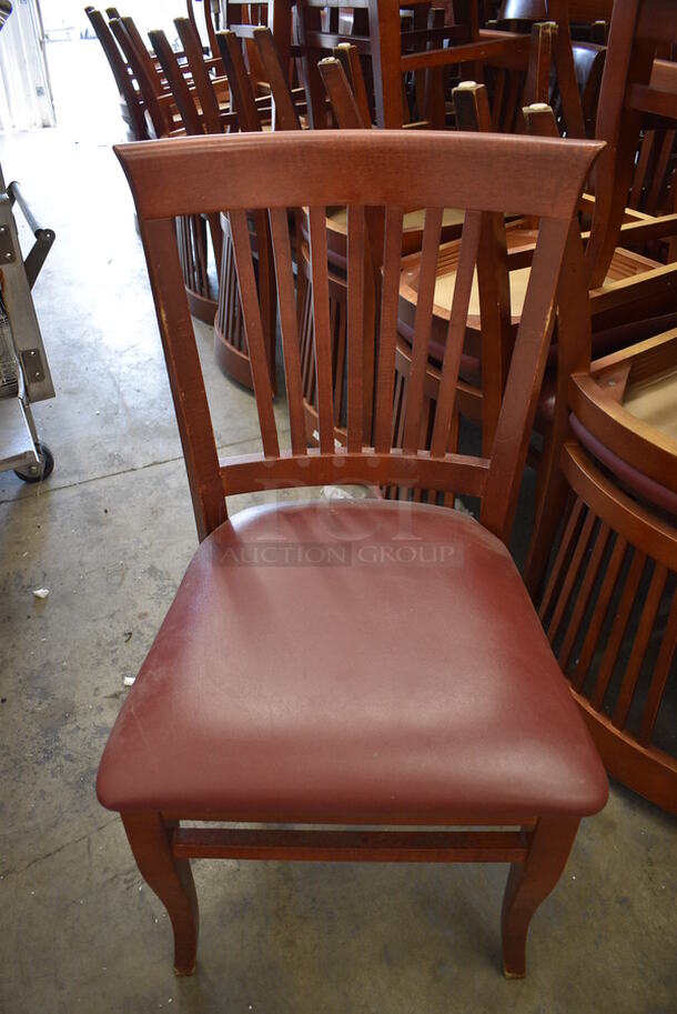 2 Wooden Dining Chairs w/ Maroon Seat Cushion. Stock Picture - Cosmetic Condition May Vary. 20x18x35. 2 Times Your Bid!