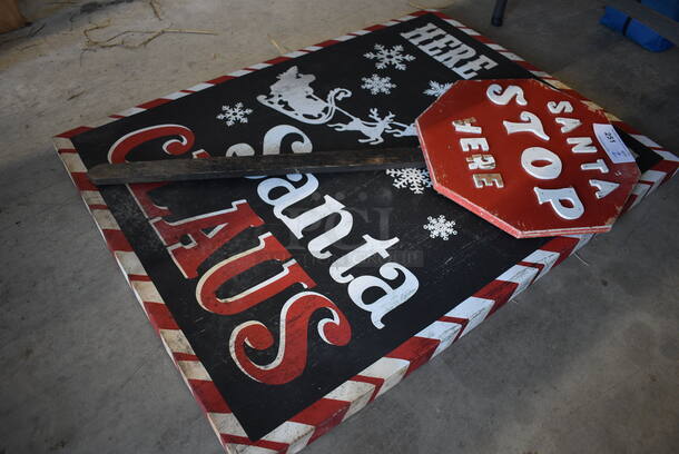 2 Signs. Santa Stop Here and Here Comes Santa Claus. 30x1.5x40, 16x2x40. 2 Times Your Bid!