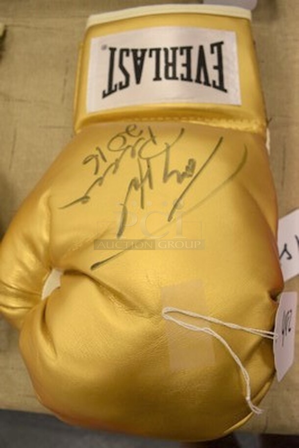 Gold Colored Boxing Glove Signed By Larry Holmes! Comes With Certificate of Authenticity!  - Image 1 of 6