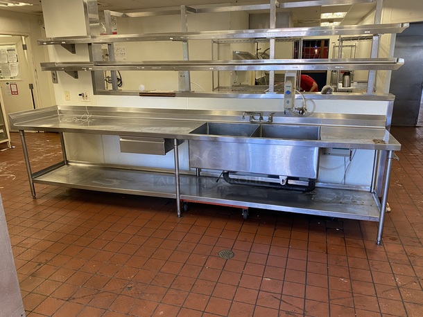 BEAUTIFUL! Stainless Steel Prep Station/Table with 2 Compartment Prep Sink  13' -0"x30"x41", all welded construction, NSF. 16 gauge, 304 stainless steel top w/6" backsplash, 18 gauge, stainless steel undershelf, stainless steel legs and adjustable stainless steel feet. with 2 (LARGE) Bay Sink, Faucet, Plumbing, Storage Drawer and Under-shelf. 13ft x 30" x 41 inches (to top of backsplash).   B-2424 Fabricated sink bowl, 24" front-to-back x 24" Wide x 12" Deep, 14 gauge, 304 stainless steel.  Roller bearing drawer, 20" x 20", stainless steel removable pan.  (2) Twist Handle Lever drains, 2" drain outlet        This piece is located on site in Modesto, CA. Shipping or Pick-Up Available. Winning Bidder must Contact PCI Auctions Southwest by 26-AUG-2020 with Arrangements for pick-up or shipping. Pick-Up for this items will not be until the weekend of 28-AUG-2020. - Image 1 of 5