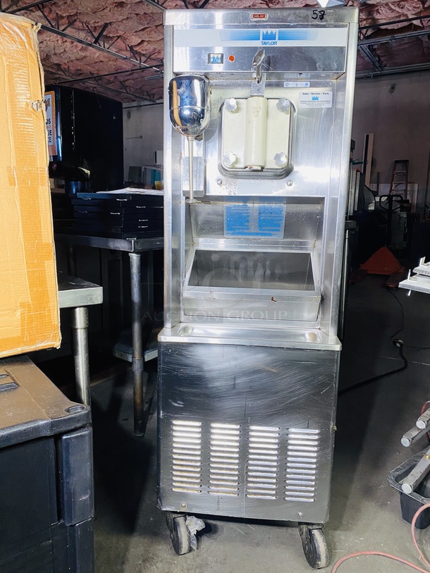 SHAKE MACHINE! Taylor Co. Model No. 441.27A Shake machine, non-heat treatment type with one (1) 7-quart freezing cylinder and one 20-quart mix hopper. Includes front mounted panel spinner and three (3) compatment refrigerated syrup rail.  On Commercial Casters 208-220V 60Hz 1Ph. 18x30x57-1/2