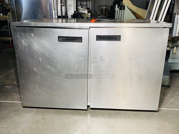 Delfield Model No. UC4048, Undercounter Refrigerator, two-section, 48"W, 11.4 cu. ft, (2) doors, stainless steel top, front & sides, 6" legs, rear-mounted, self-contained refrigeration, 1/5 hp. 115v/60/1-ph, NEMA 5-15P std. On Commercial Casters

In use until Removal. Tested. Turned on. Temp got down to 40 degrees.  - Image 1 of 5