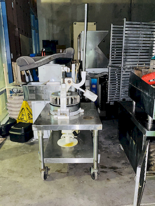 CRÈME DE LA CRÈME! Dough Divider/Rounder by Oliver - Model No. 623-N and Equipment Stand Model No. 2SU-30 on Commercial Casters.        This lot consists of: Bun Divider, hand operated, cast iron & cast aluminum construction, 36 part up to 4 oz., std. - Price New: $1580        Equipment stand: 30x30x24, 14 gauge, all welded construction, NSF. 304 stainless steel top with turned down edges, 18 gauge stainless steel undershelf and 16 gauge stainless steel legs and adjustable stainless steel feet. - Price New: $580        2x Your Bid - Image 2 of 12
