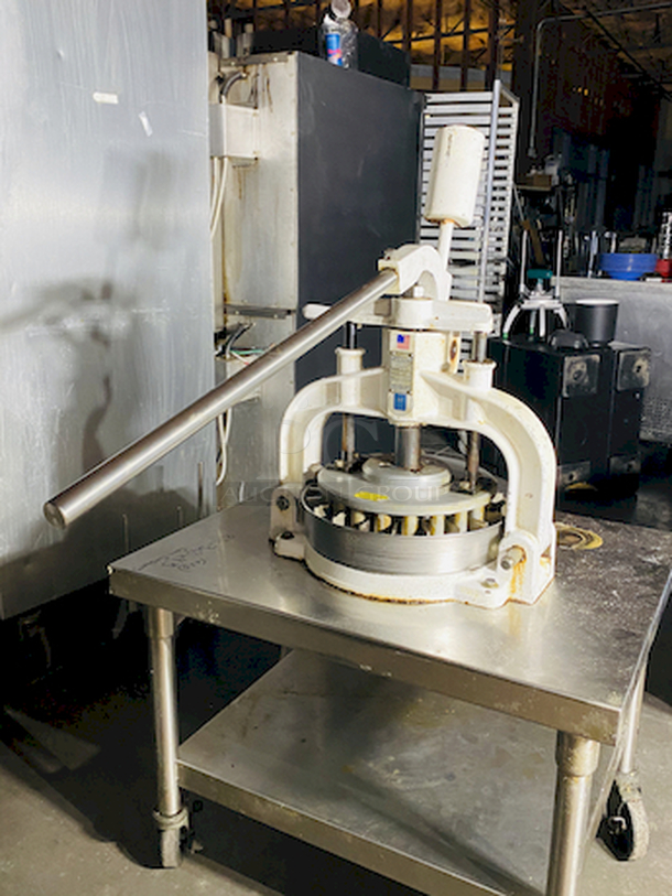 CRÈME DE LA CRÈME! Dough Divider/Rounder by Oliver - Model No. 623-N and Equipment Stand Model No. 2SU-30 on Commercial Casters.        This lot consists of: Bun Divider, hand operated, cast iron & cast aluminum construction, 36 part up to 4 oz., std. - Price New: $1580        Equipment stand: 30x30x24, 14 gauge, all welded construction, NSF. 304 stainless steel top with turned down edges, 18 gauge stainless steel undershelf and 16 gauge stainless steel legs and adjustable stainless steel feet. - Price New: $580        2x Your Bid - Image 8 of 12
