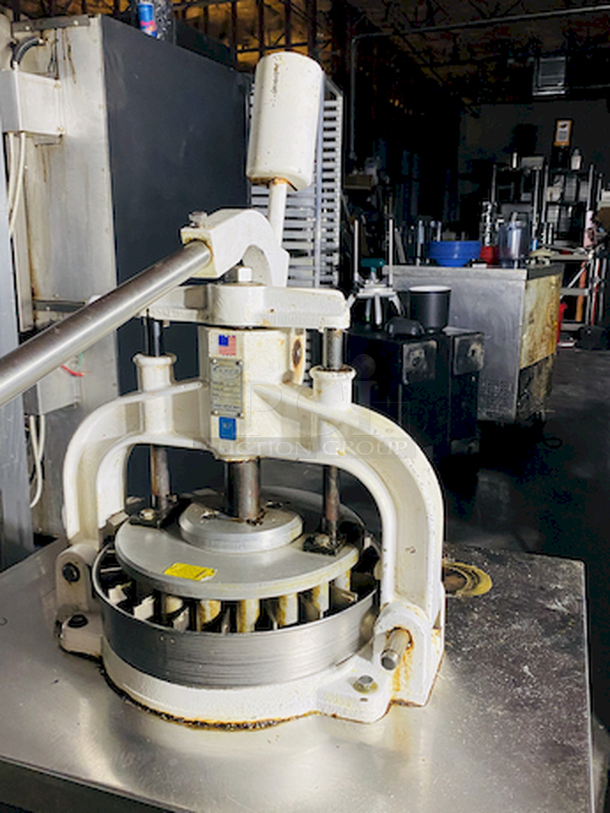 CRÈME DE LA CRÈME! Dough Divider/Rounder by Oliver - Model No. 623-N and Equipment Stand Model No. 2SU-30 on Commercial Casters.        This lot consists of: Bun Divider, hand operated, cast iron & cast aluminum construction, 36 part up to 4 oz., std. - Price New: $1580        Equipment stand: 30x30x24, 14 gauge, all welded construction, NSF. 304 stainless steel top with turned down edges, 18 gauge stainless steel undershelf and 16 gauge stainless steel legs and adjustable stainless steel feet. - Price New: $580        2x Your Bid - Image 9 of 12