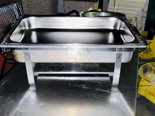 BEAUTIFUL! 8 Qt. Full Size Stainless Steel Chafer. 24x14-1/8x13
Includes: Full size chafer frame, 4" deep water pan, 2 1/2" deep food pan, 2 1/2" high lid with black handle, Fuel holder tray
 - Image 5 of 7