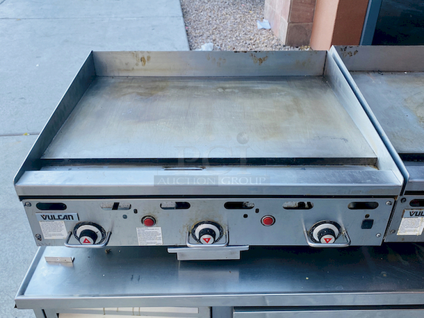 BUILT FOR HEAVY USE! Vulcan MSA-36-101 36" Countertop Natural Gas Griddle with Snap-Action Thermostatic Controls - 81,000 BTU. Width 36 Inches Depth 31 1/2 Inches Height 15 1/4 Inches Cooking Surface Width 36 Inches Cooking Surface Depth 24 Inches Stainless steel front, sides and front top ledge. Fully welded stainless and aluminized steel body frame. 11" low profile cooking height on 4" legs. 1" thick polished steel griddle plate with 12 gage, 4" stainless steel back and tapered side splashes. Grease chute is fully welded to stop grease migration. One 27,000 BTU/hr. “U” shaped aluminized steel burner and mechanical snap action thermostat for each 12" of griddle width. Chrome thermostat knob guards. Temperature adjusts from 200° to 550° F. One pilot safety for every two burners. - Image 1 of 8