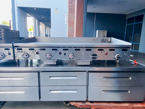 BUILT FOR HEAVY DUTY & HEAVY USE! Vulcan MSA-60-101 60" Countertop Natural Gas Griddle with Snap-Action Thermostatic Controls - 135,000 BTU.

Width	60 Inches
Depth	31 1/2 Inches
Height	15 1/4 Inches
Cooking Surface Width	60 Inches
Cooking Surface Depth	24 Inches

Stainless steel front, sides and front top ledge. Fully welded stainless and aluminized steel body frame. 11" low profile cooking height on 4" legs. 1" thick polished steel griddle plate with 12 gage, 4" stainless steel back and tapered side splashes. Grease chute is fully welded to stop grease migration. One 27,000 BTU/hr. “U” shaped aluminized steel burner and mechanical snap action thermostat for each 12" of griddle width. Chrome thermostat knob guards. Temperature adjusts from 200° to 550° F. One pilot safety for every two burners. - Image 2 of 10