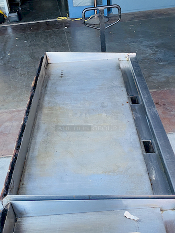 BUILT FOR HEAVY DUTY & HEAVY USE! Vulcan MSA-60-101 60" Countertop Natural Gas Griddle with Snap-Action Thermostatic Controls - 135,000 BTU.

Width	60 Inches
Depth	31 1/2 Inches
Height	15 1/4 Inches
Cooking Surface Width	60 Inches
Cooking Surface Depth	24 Inches

Stainless steel front, sides and front top ledge. Fully welded stainless and aluminized steel body frame. 11" low profile cooking height on 4" legs. 1" thick polished steel griddle plate with 12 gage, 4" stainless steel back and tapered side splashes. Grease chute is fully welded to stop grease migration. One 27,000 BTU/hr. “U” shaped aluminized steel burner and mechanical snap action thermostat for each 12" of griddle width. Chrome thermostat knob guards. Temperature adjusts from 200° to 550° F. One pilot safety for every two burners. - Image 8 of 10
