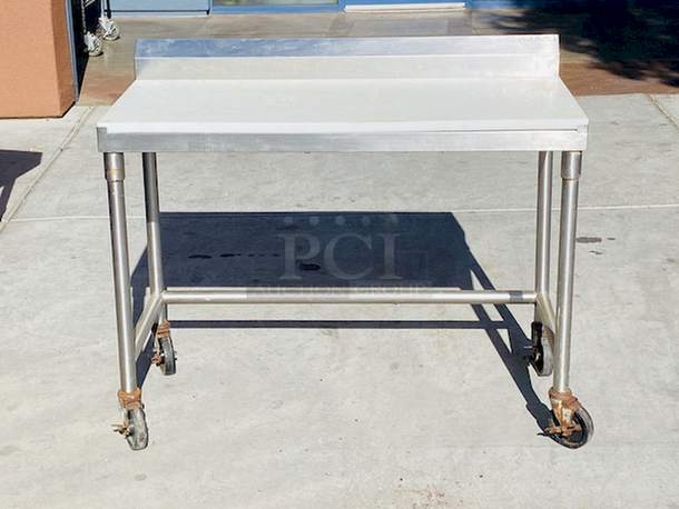 AWESOME!! Stainless Steel Table 48" LONG
Custom Model No. 3PTCT-30
Cutting Table, 48"x24" x 40", all-welded construction, NSF. To include 1/2" poly top, and 5" backsplash, 18 gauge, 304 stainless steel undershelf, 16 gauge, 304 stainless steel frame and legs, On COMMERCIAL Casters

 - Image 1 of 4