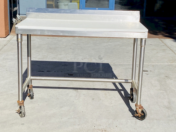 AWESOME!! Stainless Steel Table 48" LONG
Custom Model No. 3PTCT-30
Cutting Table, 48"x24" x 40", all-welded construction, NSF. To include 1/2" poly top, and 5" backsplash, 18 gauge, 304 stainless steel undershelf, 16 gauge, 304 stainless steel frame and legs, On COMMERCIAL Casters

 - Image 2 of 4