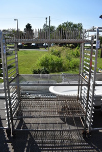 Metal 4 Tier Shelving Unit on Commercial Casters. 48x24x68. BUYER MUST DISMANTLE. PCI CANNOT  DISMANTLE FOR SHIPPING. PLEASE CONSIDER FREIGHT CHARGES.