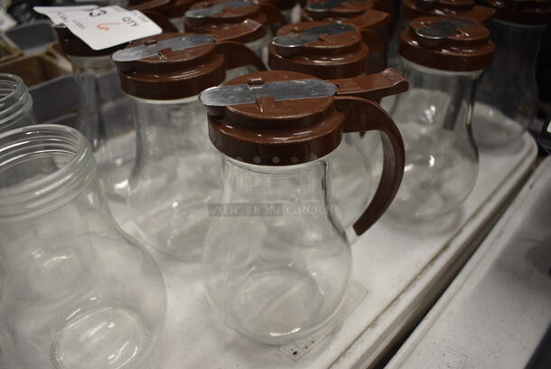 9 Syrup Pourers w/ Brown Lids. 4.5x3.5x6. 9 Times Your Bid!