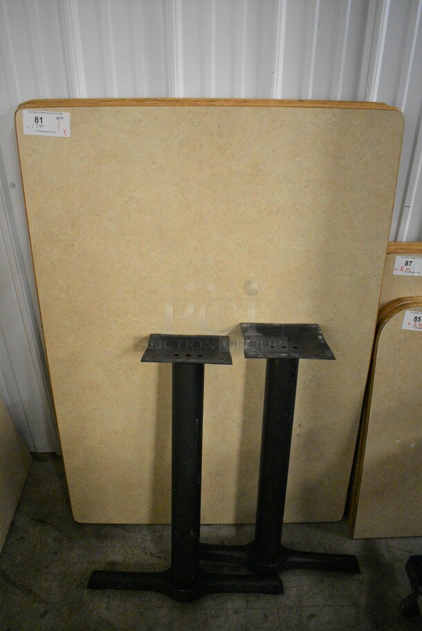 Tabletop and 2 Black Metal Straight Leg Table Bases. Stock Picture - Cosmetic Condition May Vary. 33.5x47.5x30 - Image 1 of 3