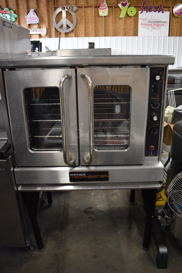 BEAUTIFUL! Montague Technostar Stainless Steel Commercial Gas Powered Full Size Convection Oven w/ View Through Doors, Metal Oven Racks and Thermostatic Controls on Metal Legs. 38x35x62 - Image 1 of 10