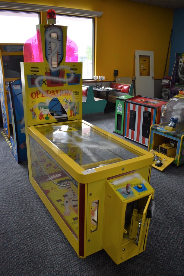 PAOKAI Electronic Enterprise Model 830 Yellow Metal Operation Skill Arcade Game on Casters. 110 Volts, 1 Phase. 28.5x66x85