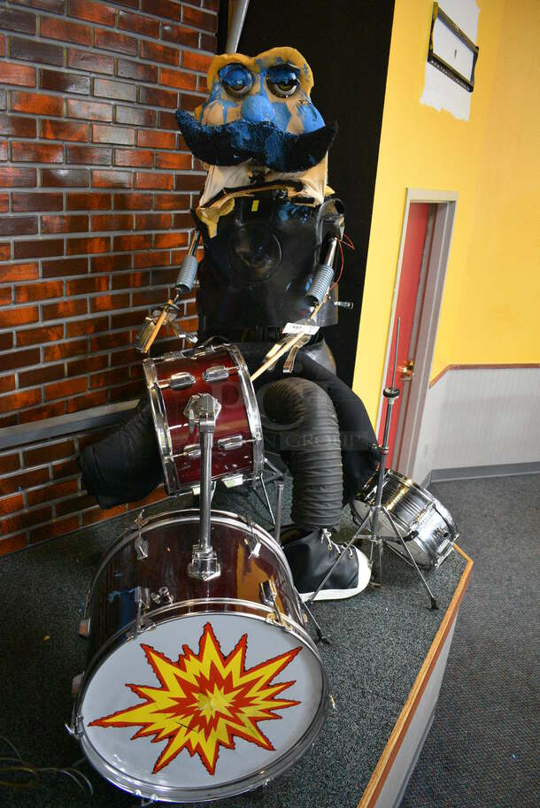 Metal Animatronic Band Member w/ Mustache, 2 Black Shoes and Fake Drum Set. 28x30x68, 21x33x35. BUYER MUST REMOVE