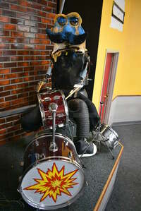 Metal Animatronic Band Member w/ Mustache, 2 Black Shoes and Fake Drum Set. 28x30x68, 21x33x35. BUYER MUST REMOVE