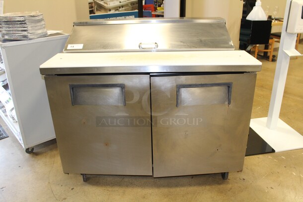 GREAT FIND! True Model TSSU-48-12 Commercial Stainless Steel Two Door Refrigerated Sandwich/Salad Prep Table On Commercial Casters With Commercial Plastic Inserts. 48x30.5x42.5. 115V/60Hz. Working When Pulled!  - Image 1 of 7