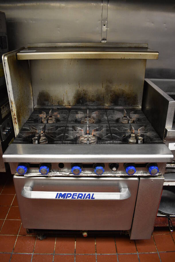 BEAUTIFUL! Imperial Stainless Steel Commercial Propane Gas Powered 6 Burner Range w/ Lower Oven and Overshelf on Commercial Casters. This Unit Will Be Professionally Uninstalled. 36x32x57. Tested and Working! - Image 1 of 6