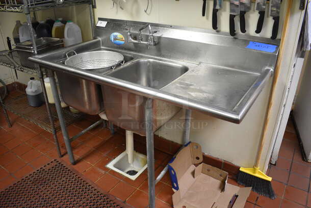 Stainless Steel Commercial 2 Well Sink w/ Right Side Drainboard, Faucet and Handles. This Unit Will Be Professionally Uninstalled. 57x28x44. Bays 12x20x14. Drainboard 16x23x2 - Image 1 of 4