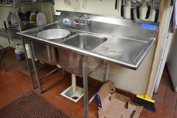 Stainless Steel Commercial 2 Well Sink w/ Right Side Drainboard, Faucet and Handles. This Unit Will Be Professionally Uninstalled. 57x28x44. Bays 12x20x14. Drainboard 16x23x2