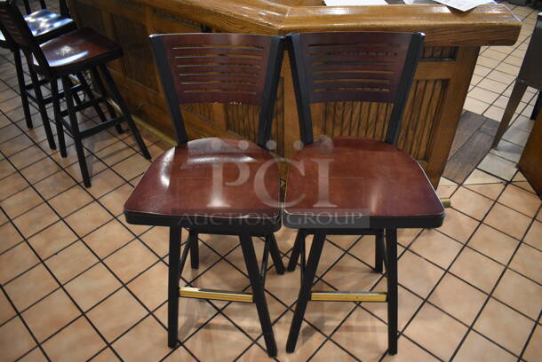 2 Black Metal Bar Height Swivel Chairs w/ Wooden Seats and Wooden Backrest. Stock Picture - Cosmetic Condition May Vary. 18x16x42. 2 Times Your Bid! - Image 1 of 4