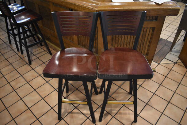 2 Black Metal Bar Height Swivel Chairs w/ Wooden Seats and Wooden Backrest. Stock Picture - Cosmetic Condition May Vary. 18x16x42. 2 Times Your Bid! - Image 1 of 5