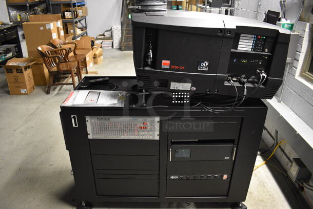 MARVELOUS! 2014 Barco Model DP2K-12C Commercial Countertop DLP Cinema Projector on Cabinet w/ Film-Tech FT21 Automation Cinema System, Gefer Cinema Scaler Pro III and Tripp Lite Surge Protector. 200-240 Volts. See Lot 2 For Additional Pictures! 26x38x22, 24x53x38. BUYER MUST REMOVE. Tested and Working!