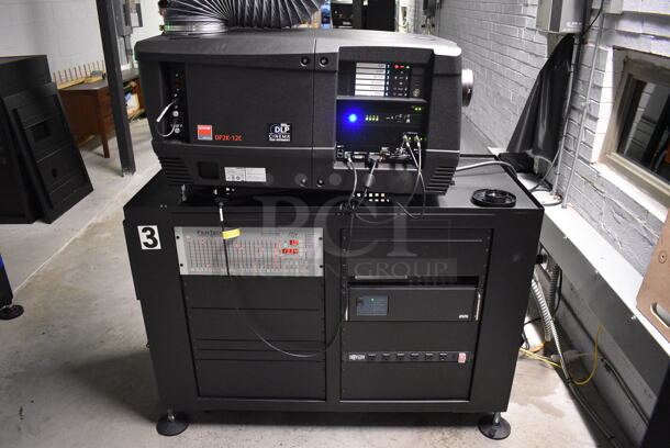 MARVELOUS! 2014 Barco Model DP2K-12C Commercial Countertop DLP Cinema Projector on Cabinet w/ Film-Tech FT21 Automation Cinema System, Gefer Cinema Scaler Pro III, Dolby CP750 Digital Cinema Processor, DCM Powercom, TV Monitor and Tripp Lite Surge Protector. 200-240 Volts. See Lot 12 For Additional Pictures! 26x38x22, 24x53x38. BUYER MUST REMOVE. Tested and Working!