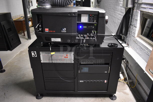 MARVELOUS! 2014 Barco Model DP2K-12C Commercial Countertop DLP Cinema Projector on Cabinet w/ Film-Tech FT21 Automation Cinema System, Gefer Cinema Scaler Pro III, Dolby CP750 Digital Cinema Processor, DCM Powercom, TV Monitor and Tripp Lite Surge Protector. 200-240 Volts. See Lot 12 For Additional Pictures! 26x38x22, 24x53x38. BUYER MUST REMOVE. Tested and Working! - Image 1 of 12