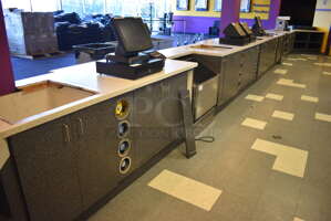 Serving Counter w/ Gray Doors, White Countertop and 16 Rear In Counter Cup Dispensers. Approximately 450" Wide See Picture For Dimensions. BUYER MUST REMOVE