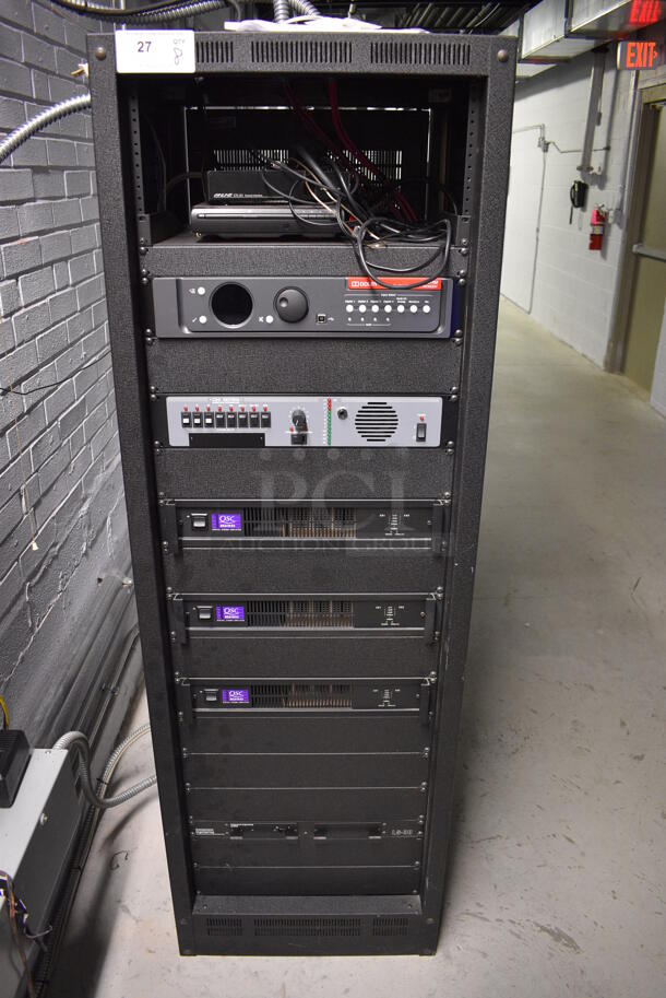 8 FANTASTIC! Items In Black Metal Rack Unit; Inline CTL101 Central Interface, Unit, Dolby CP750 Digital Cinema Processor, CM Series, 3 QSC BCA1622 Digital Cinema Amplifiers and Component Engineering LS-30-M. 22.5x22x69. 8 Times Your Bid!