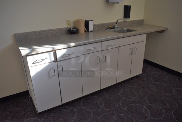 Counter w/ White Doors, Gray Countertop and Sink Basin. 103x25x40. Bay 16x12x8. BUYER MUST REMOVE