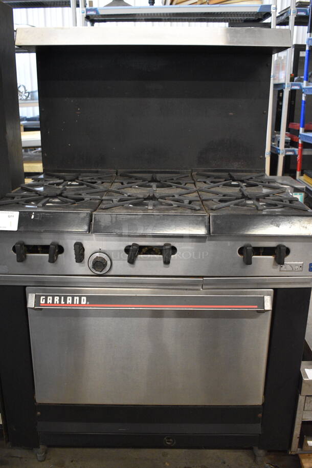 COOL! Garland Stainless Steel Commercial Gas Powered 6 Burner Range w/Lower Oven and Metal Over shelf. 36x31x59 - Image 1 of 6