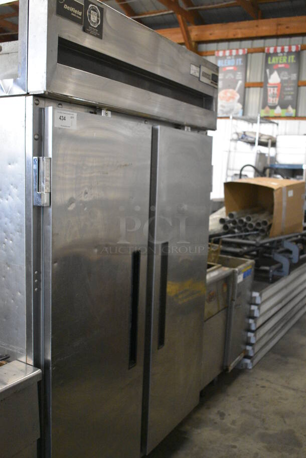 GREAT! Delfield Model 6151XL-S Stainless Steel Commercial 2 Door Reach In Freezer w/ Poly Coated Racks on Commercial Casters. 115 Volts, 1 Phase. 51x32x80. Tested and Working!