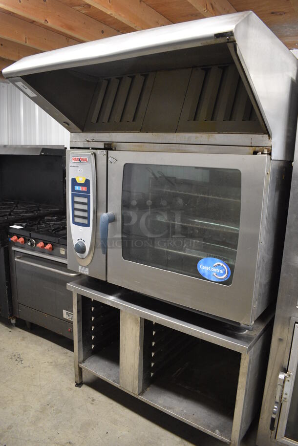 BEAUTIFUL! Rational Model SCC62 Stainless Steel Commercial Electric Powered Combitherm Self Cooking Center Convection Oven w/ Stainless Steel Hood on Equipment Stand. 208 Volts, 3 Phase. 42x52x74