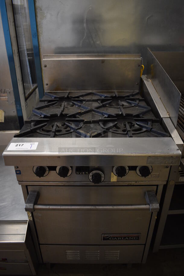 NICE! Garland Model H28 Stainless Steel Commercial Natural Gas Powered 4 Burner Range w/ Lower Oven on Commercial Casters. 24x33x45