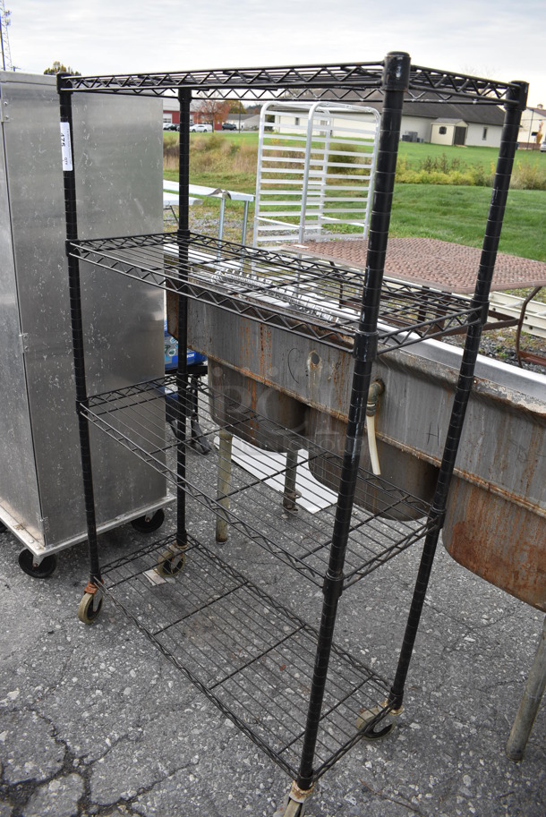 Black Finish 4 Tier Metro Style Shelving Unit on Casters. 36x14x59. BUYER MUST DISMANTLE. PCI CANNOT DISMANTLE FOR SHIPPING. PLEASE CONSIDER FREIGHT CHARGES - Image 1 of 2