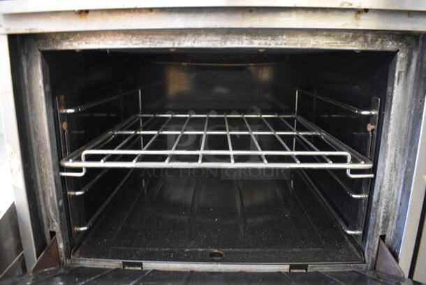 NICE! Garland Model H28 Stainless Steel Commercial Natural Gas Powered 4 Burner Range w/ Lower Oven on Commercial Casters. 24x33x45 - Image 6 of 10