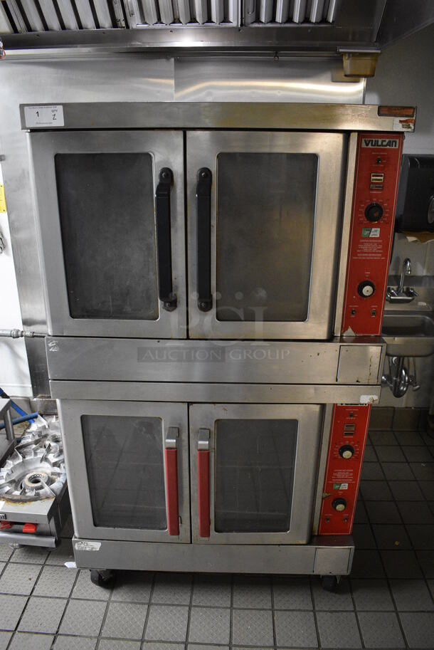 2 FANTASTIC! Vulcan Stainless Steel Commercial Gas Powered Full Size Convection Ovens w/ View Through Doors, Metal Oven Racks and Thermostatic Controls on Commercial Casters. BUYER MUST REMOVE. 40.5x38x69. 2 Times Your Bid!