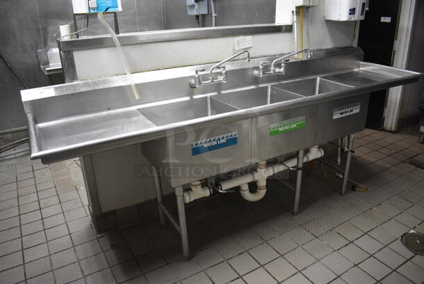Stainless Steel Commercial 3 Bay Sink w/ Dual Drainboards, Faucets and Handles. BUYER MUST REMOVE. 108x26x41.5. Bays 20x20x12. Drainbaords 22x22x2 - Image 1 of 5