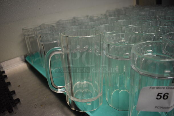 29 Poly Clear Tall Mugs on Green Tray. 4.5x3.5x6.5. 29 Times Your Bid! - Image 1 of 3