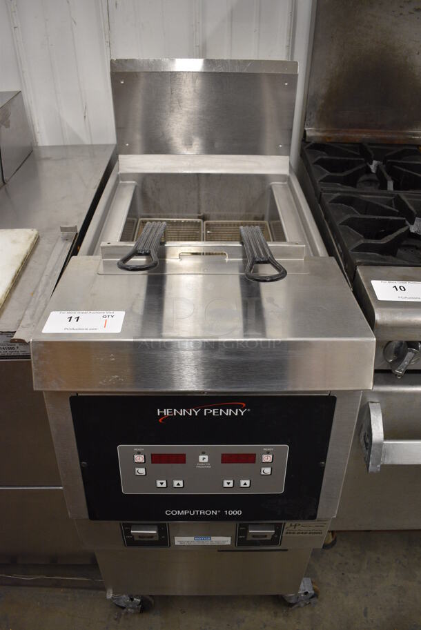 BEAUTIFUL! 2018 Henny Penny Model OFG-321 Stainless Steel Commercial Floor Style Natural Gas Powered Deep Fat Fryer w/ 2 Metal Fry Baskets on Commercial Casters. 85,000 BTU. 17x34x44 - Image 1 of 7