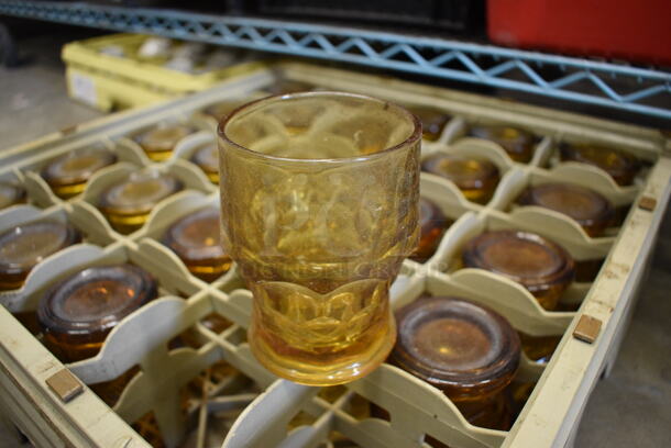 24 Amber Colored Beverage Glasses in Dish Caddy. 3x3x4. 24 Times Your Bid!