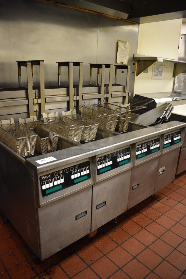 GORGEOUS! Pitco Frialator Stainless Steel Commercial Floor Style Gas Powered 4 Bay Deep Fat Fryer w/ Filtration System, 8 Metal Fry Baskets and 4 Metal Lids on Commercial Casters. 110,000 BTU. 62.5x39x55. Unit Was Working When Restaurant Closed! - Image 1 of 10
