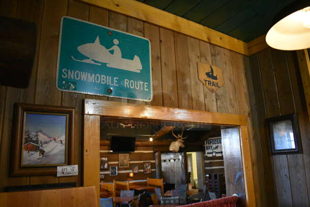 ALL ONE MONEY! Lot of Various Wall Decorations Including 5 Pictures; Skiing Picture, Black and White Dining Room Picture, Snowmobile Route Sign, Trail Sign and Winter Scene! BUYER MUST REMOVE - Image 1 of 5